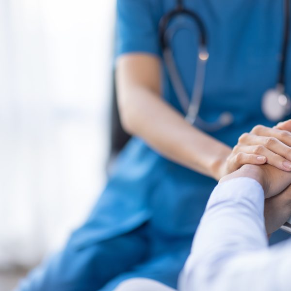 Clinician holding a patient's hands